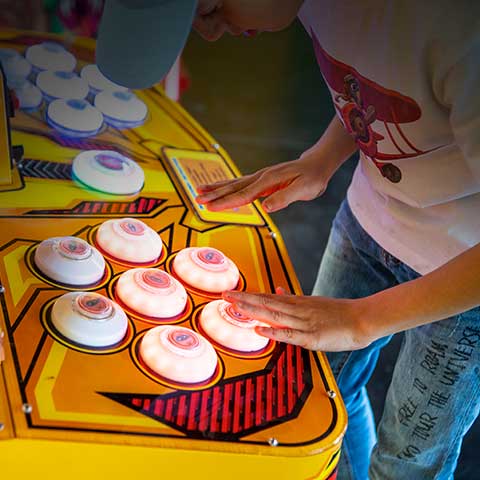 Child engaged in one of the Fairground Games machines.