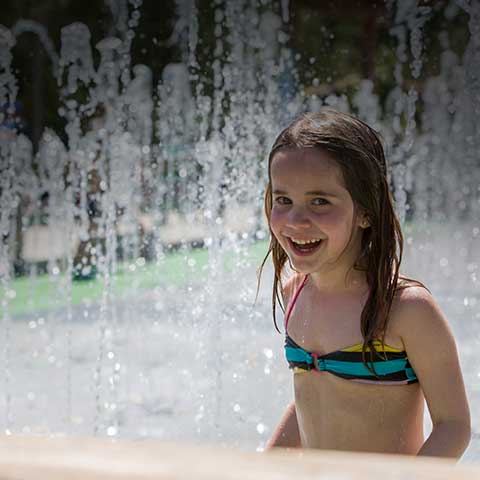 Girl smiling at camera in the Water Maze.