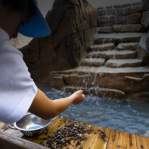 Boy collecting diamonds at the Diamond River attraction.