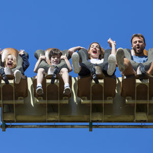 Family riding the Sendaviva free fall attraction. A father, a mother and a boy and a girl.